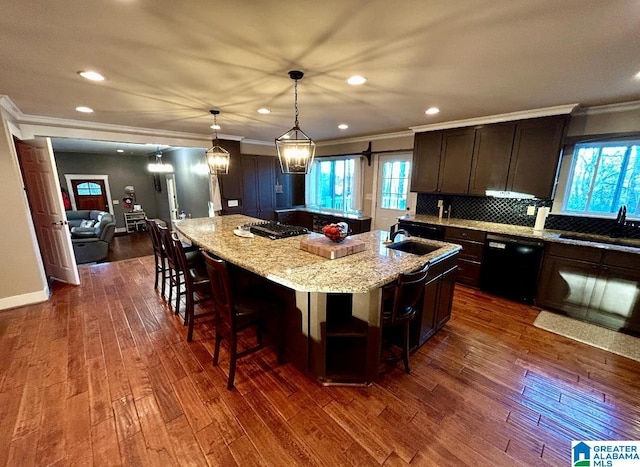 kitchen with black dishwasher, dark wood-type flooring, a spacious island, and a sink