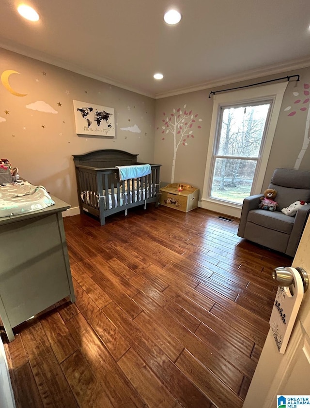 bedroom with recessed lighting, visible vents, crown molding, and hardwood / wood-style flooring