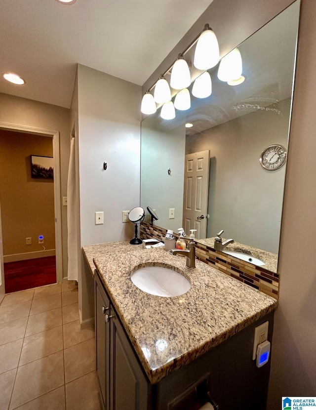 bathroom with tile patterned flooring, vanity, and baseboards