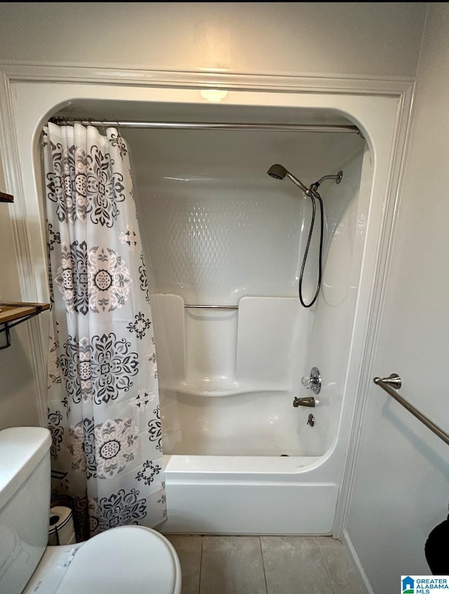 bathroom featuring toilet, tile patterned flooring, and shower / bath combo with shower curtain