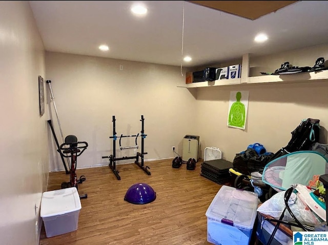 exercise area with recessed lighting and wood finished floors