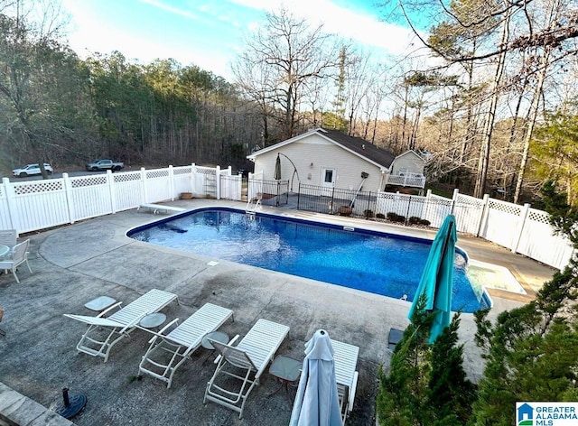 view of swimming pool featuring a fenced in pool, a diving board, a patio, and fence