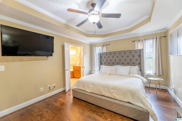 bedroom featuring baseboards, a raised ceiling, wood finished floors, and ornamental molding