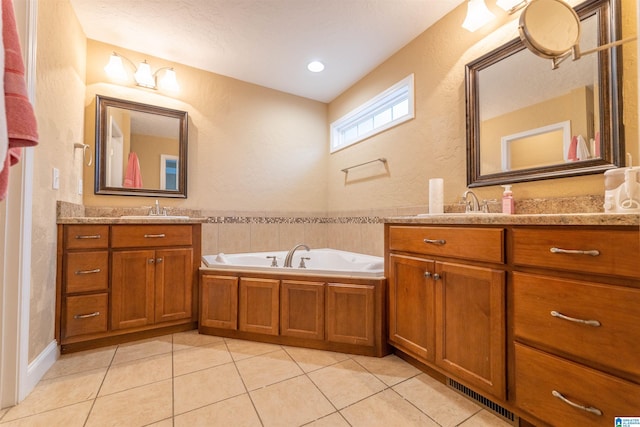 full bath featuring tile patterned flooring, visible vents, two vanities, and a sink