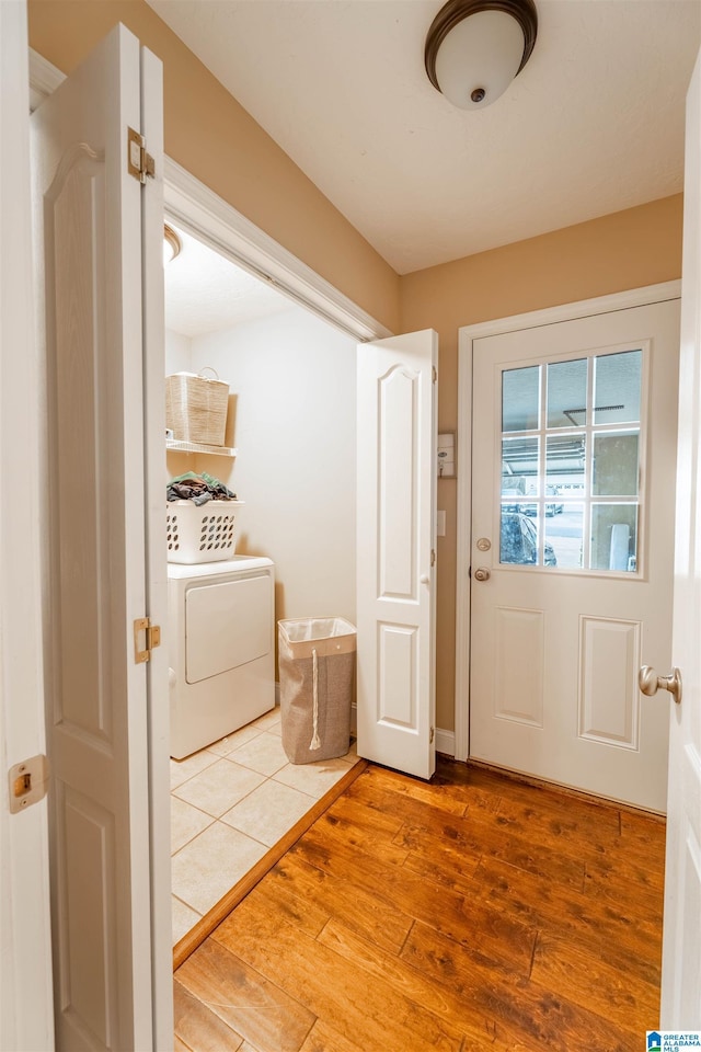 doorway to outside featuring washer / dryer and light wood-type flooring