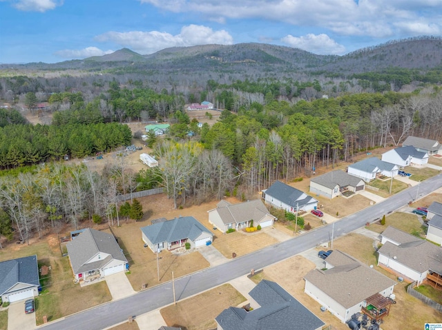 bird's eye view with a residential view, a mountain view, and a wooded view