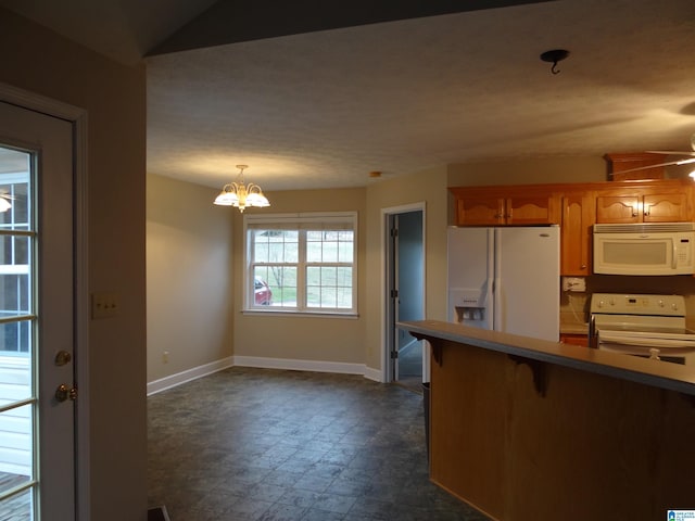 kitchen with a chandelier, a breakfast bar area, white appliances, baseboards, and brown cabinets