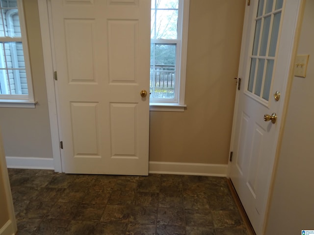 foyer entrance with plenty of natural light and baseboards