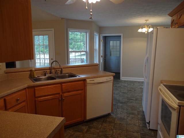 kitchen with ceiling fan, white appliances, a sink, light countertops, and stone finish flooring