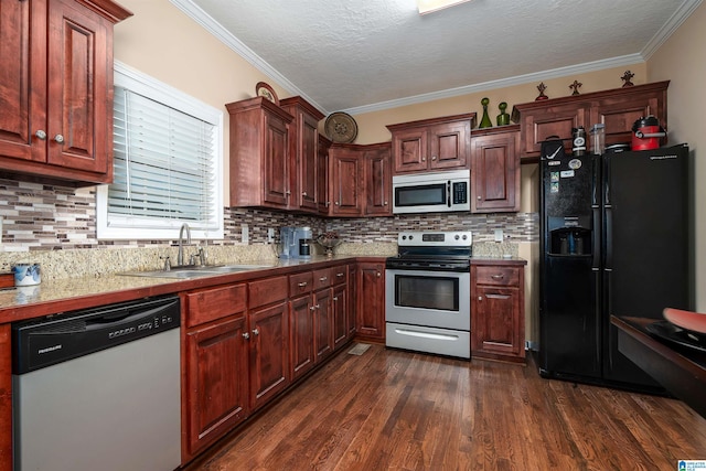 kitchen featuring tasteful backsplash, dark wood-type flooring, stainless steel appliances, crown molding, and a sink