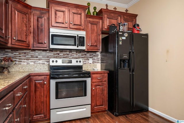 kitchen featuring crown molding, stainless steel appliances, decorative backsplash, and light countertops