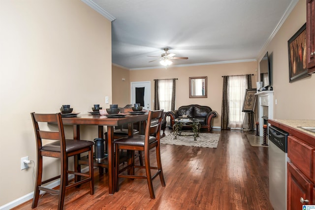 dining room with dark wood-style floors, ceiling fan, baseboards, and crown molding