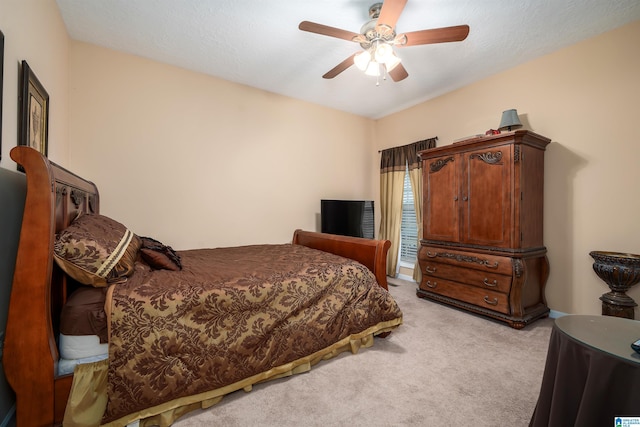 bedroom with ceiling fan and light colored carpet