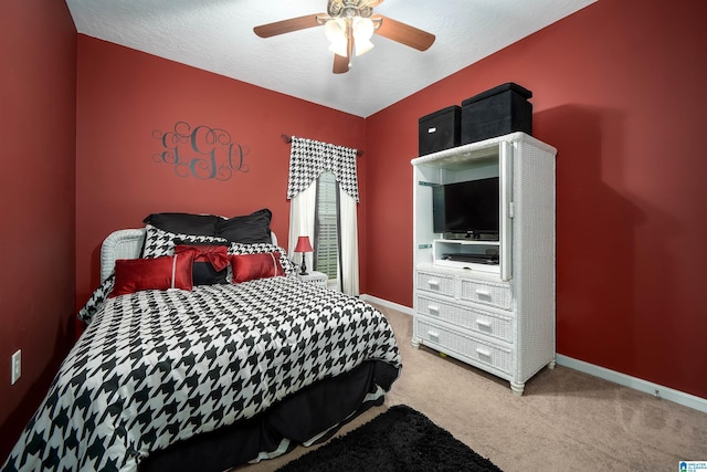 bedroom featuring carpet flooring, ceiling fan, a textured ceiling, and baseboards