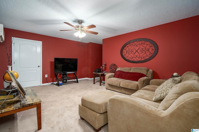 living room featuring carpet, ceiling fan, a textured ceiling, and baseboards