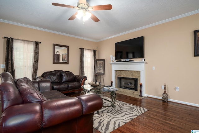 living area featuring a premium fireplace, wood finished floors, and crown molding