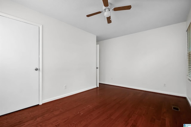 unfurnished bedroom with a ceiling fan, visible vents, baseboards, and wood finished floors