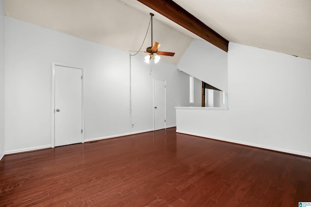 unfurnished living room with a ceiling fan, vaulted ceiling with beams, baseboards, and wood finished floors