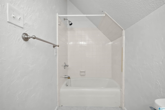 bathroom with a textured ceiling, a textured wall, and shower / tub combination