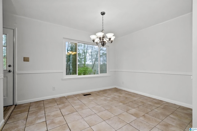 unfurnished dining area featuring a chandelier, visible vents, and baseboards