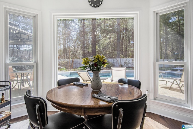 dining area featuring baseboards and wood finished floors