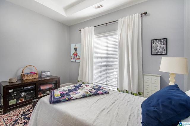 bedroom featuring baseboards and visible vents