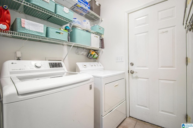 laundry area featuring laundry area, independent washer and dryer, and light tile patterned flooring