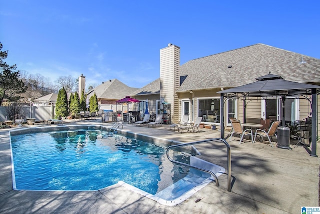 view of swimming pool with a fenced in pool, fence, a patio, and a gazebo