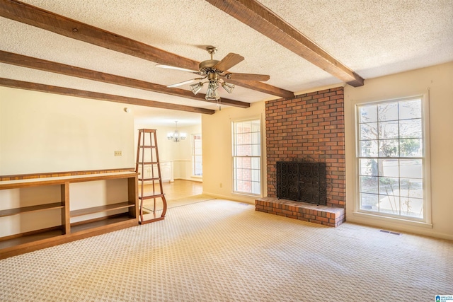 unfurnished living room featuring a brick fireplace, carpet, visible vents, and beam ceiling