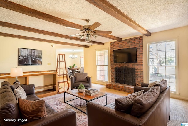 living area featuring a textured ceiling, ceiling fan with notable chandelier, a brick fireplace, beam ceiling, and carpet