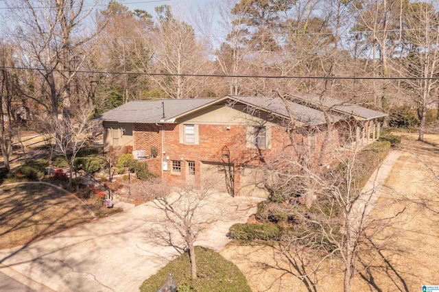 view of front facade with concrete driveway and brick siding