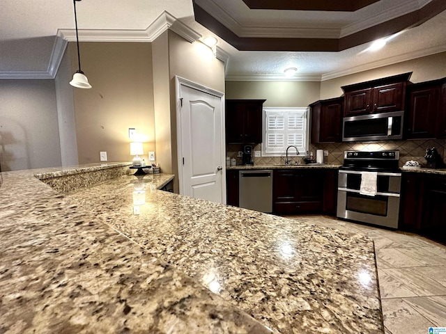 kitchen featuring stainless steel appliances, tasteful backsplash, ornamental molding, dark brown cabinets, and light stone countertops