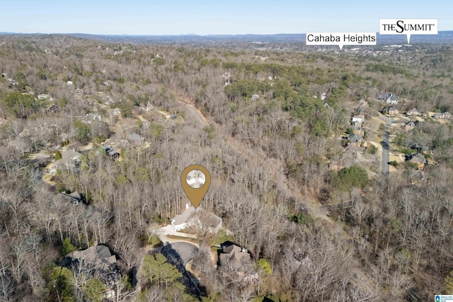 drone / aerial view with a wooded view