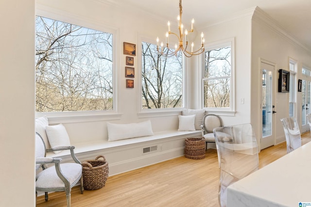 interior space with a wealth of natural light, visible vents, and an inviting chandelier