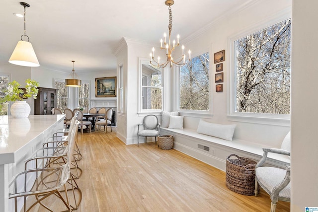 dining room with visible vents, light wood-type flooring, and a healthy amount of sunlight