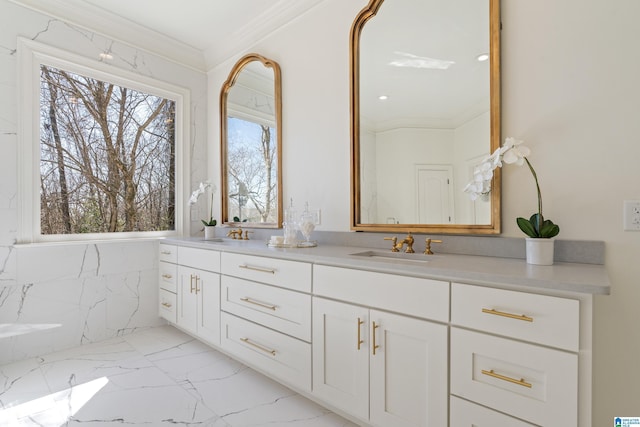 bathroom with marble finish floor, ornamental molding, and vanity