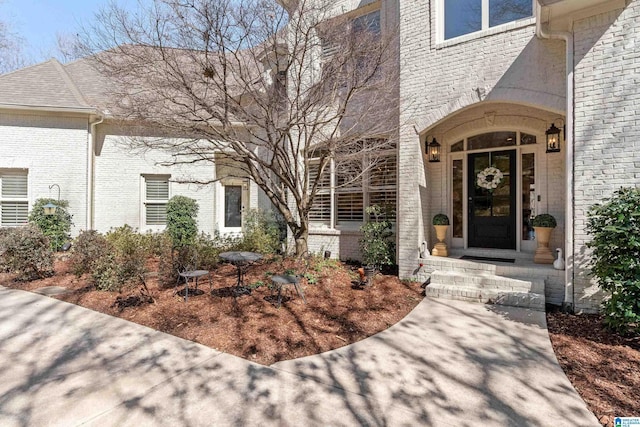 doorway to property with brick siding