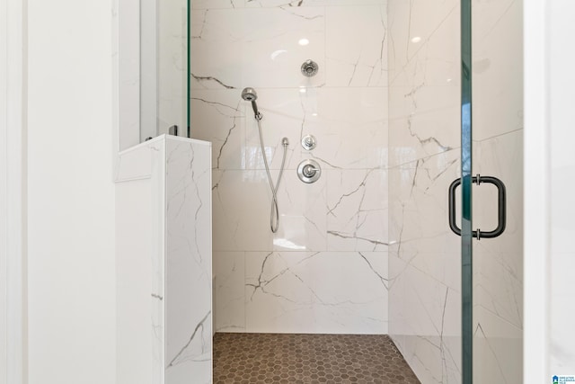 full bath featuring a marble finish shower