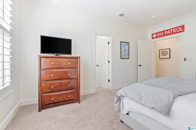 bedroom with visible vents, carpet floors, baseboards, and ornamental molding