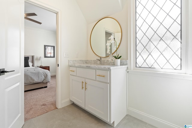 ensuite bathroom with vanity, ceiling fan, tile patterned flooring, ensuite bathroom, and crown molding