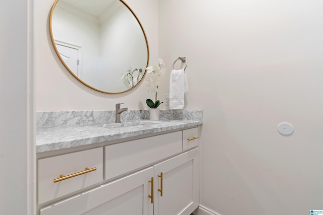 bathroom featuring vanity, baseboards, and ornamental molding