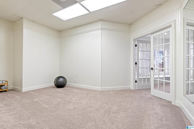 workout room featuring carpet flooring, a paneled ceiling, and french doors