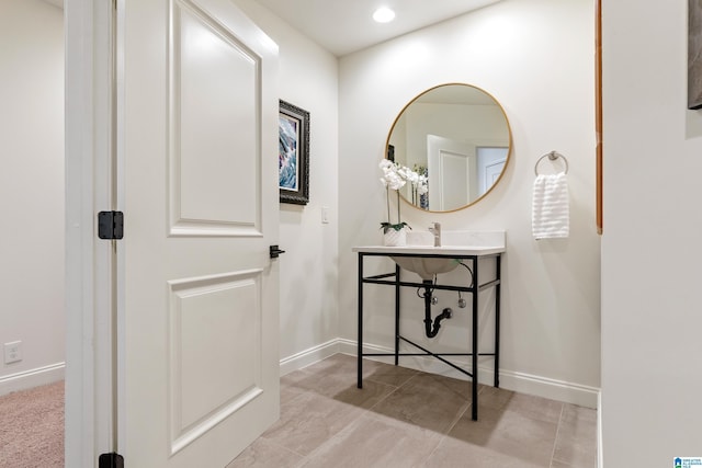 bathroom with recessed lighting and baseboards