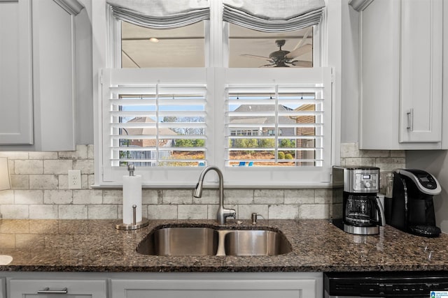 kitchen with backsplash, dishwashing machine, plenty of natural light, and a sink