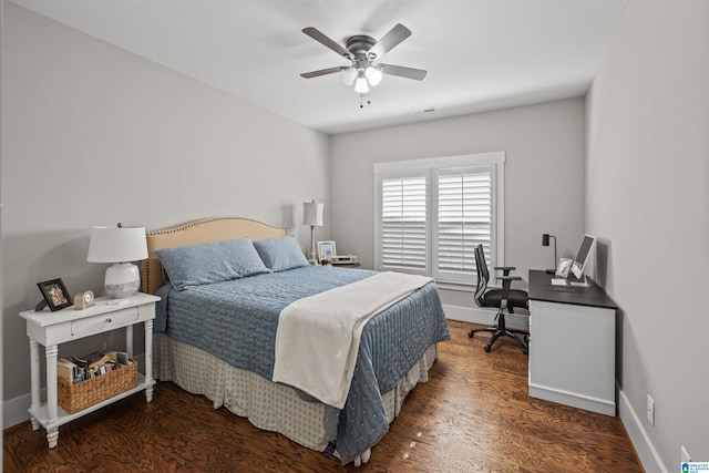 bedroom featuring a ceiling fan, visible vents, wood finished floors, and baseboards