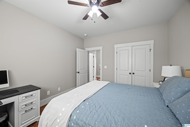 bedroom with a closet, baseboards, and ceiling fan