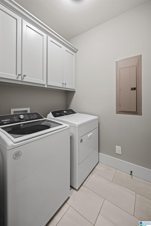 laundry room featuring baseboards, washing machine and dryer, electric panel, light tile patterned floors, and cabinet space