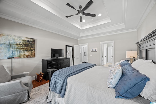 bedroom featuring wood finished floors, a tray ceiling, recessed lighting, ceiling fan, and crown molding