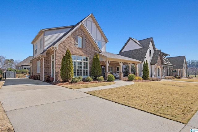 view of front of property featuring brick siding, covered porch, and concrete driveway