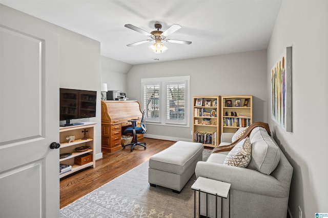 office space with baseboards, wood finished floors, and a ceiling fan